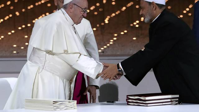 Pope Francis shakes hands with Grand Imam of al-Azhar Sheikh Ahmed al-Tayeb during an inter-religious meeting at the Founder's Memorial in Abu Dhabi