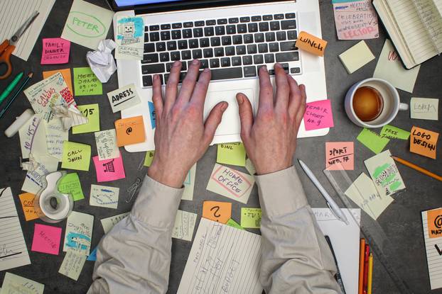 Top,View,On,Man,Working,On,Laptop,Computer,With,Notes