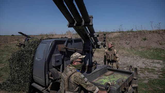 Ukrainian servicemen prepare a small MLRS for firing toward Russian troops near a front line in Zaporizhzhia region