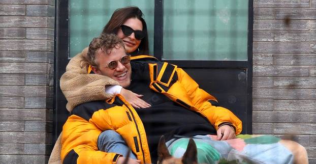 Emily Ratajkowski and husband Sebastian Bear-McClard share a romantic moment as they cuddle each other while watching dogs play at park in NYC