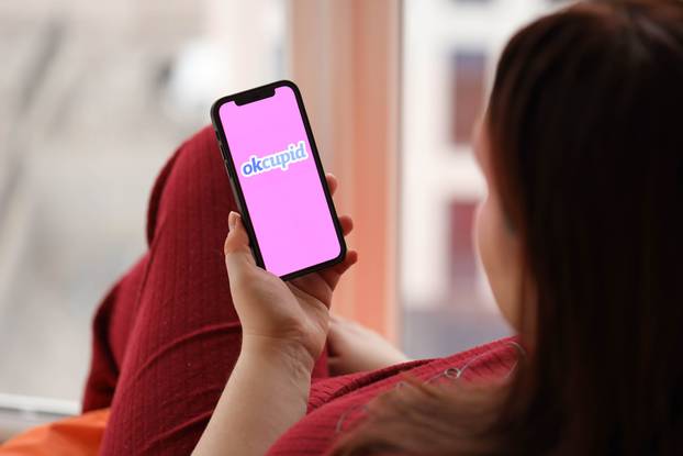 KYIV, UKRAINE - FEBRUARY 23, 2024 Okcupid logo of famous dating website or app on iPhone display