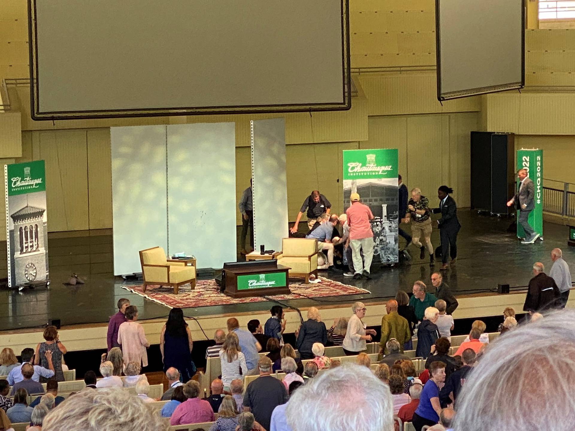 Author Salman Rushdie is helped by people after he was stabbed at the Chautauqua Institution