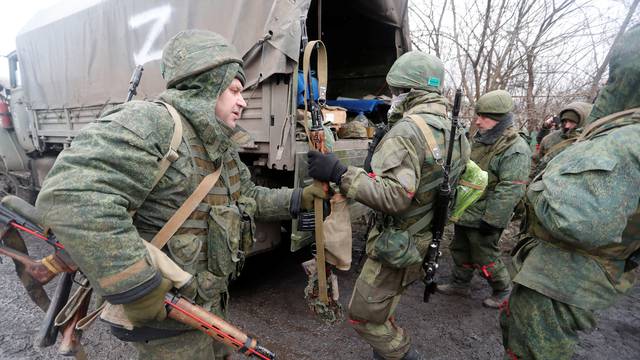 Service members of pro-Russian troops gather in a settlement in Donetsk region