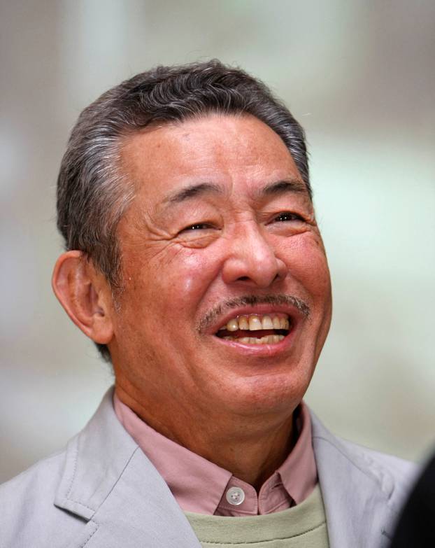 FILE PHOTO: Japanese designer Issey Miyake talks to reporters at the exhibition "U-Tsu-Wa" in Tokyo, Japan