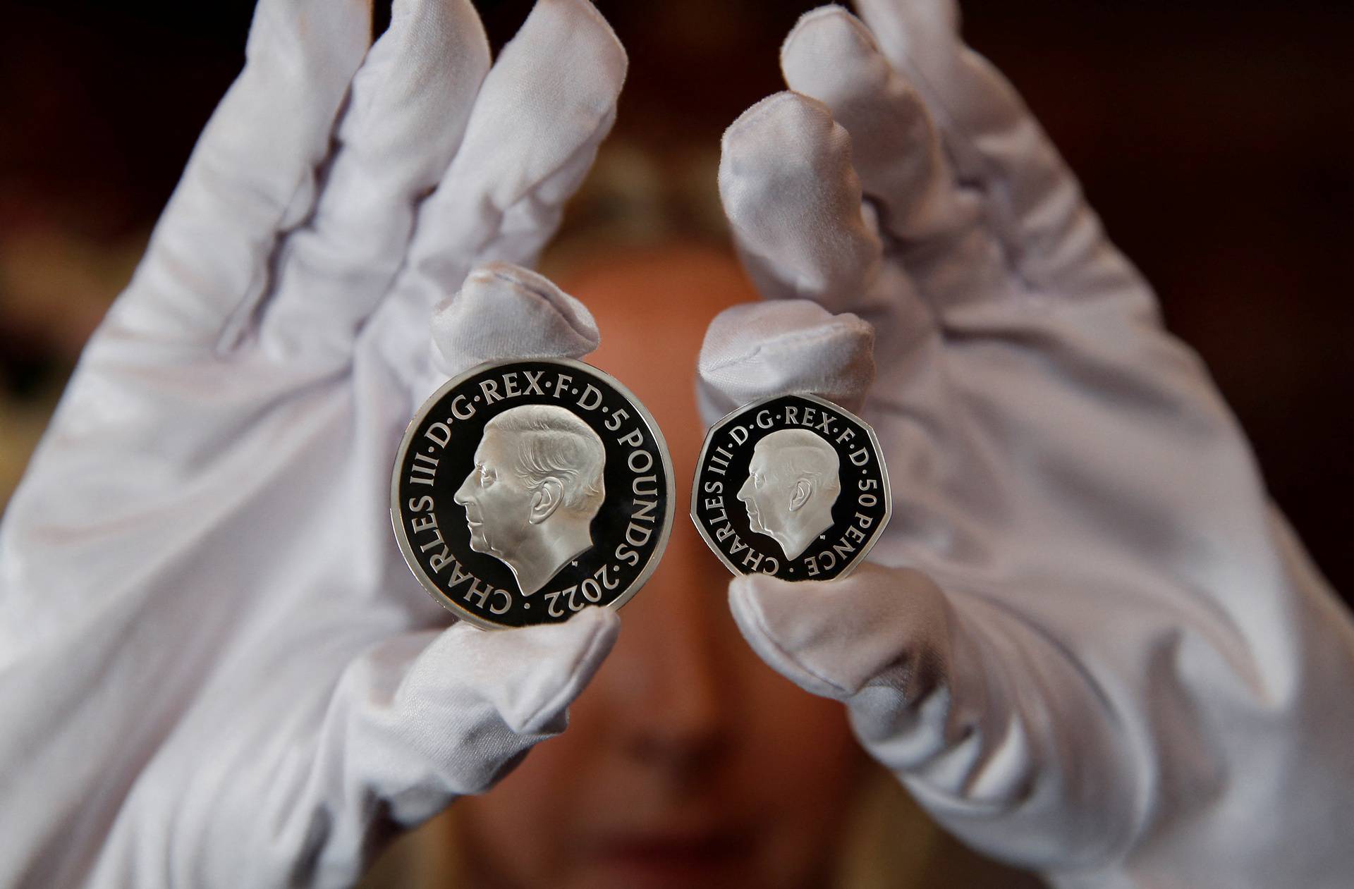 The official coin effigy of Britain’s King Charles III is seen on a £5 crown and 50 pence coin, unveiled by The Royal Mint, in London