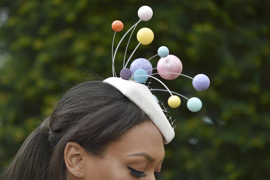 Britain Horse Racing Ladies Day Racegoer wears hat