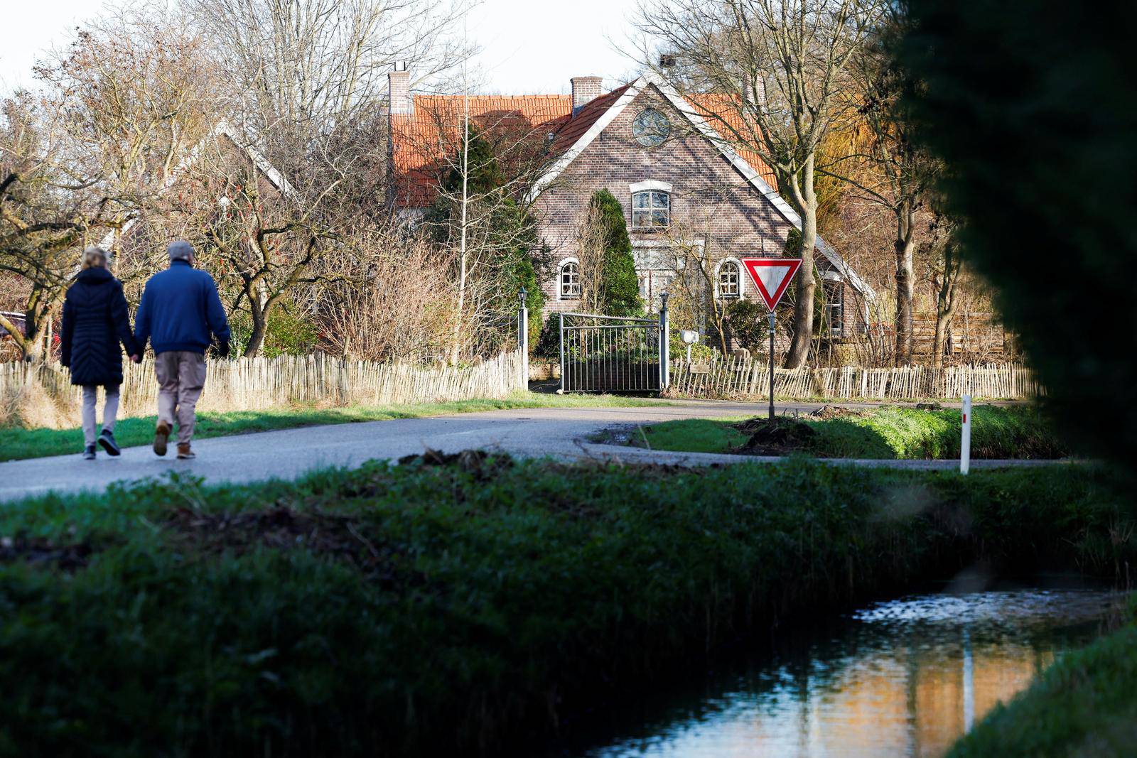 People walk on a street in the Dutch village of Ommeren