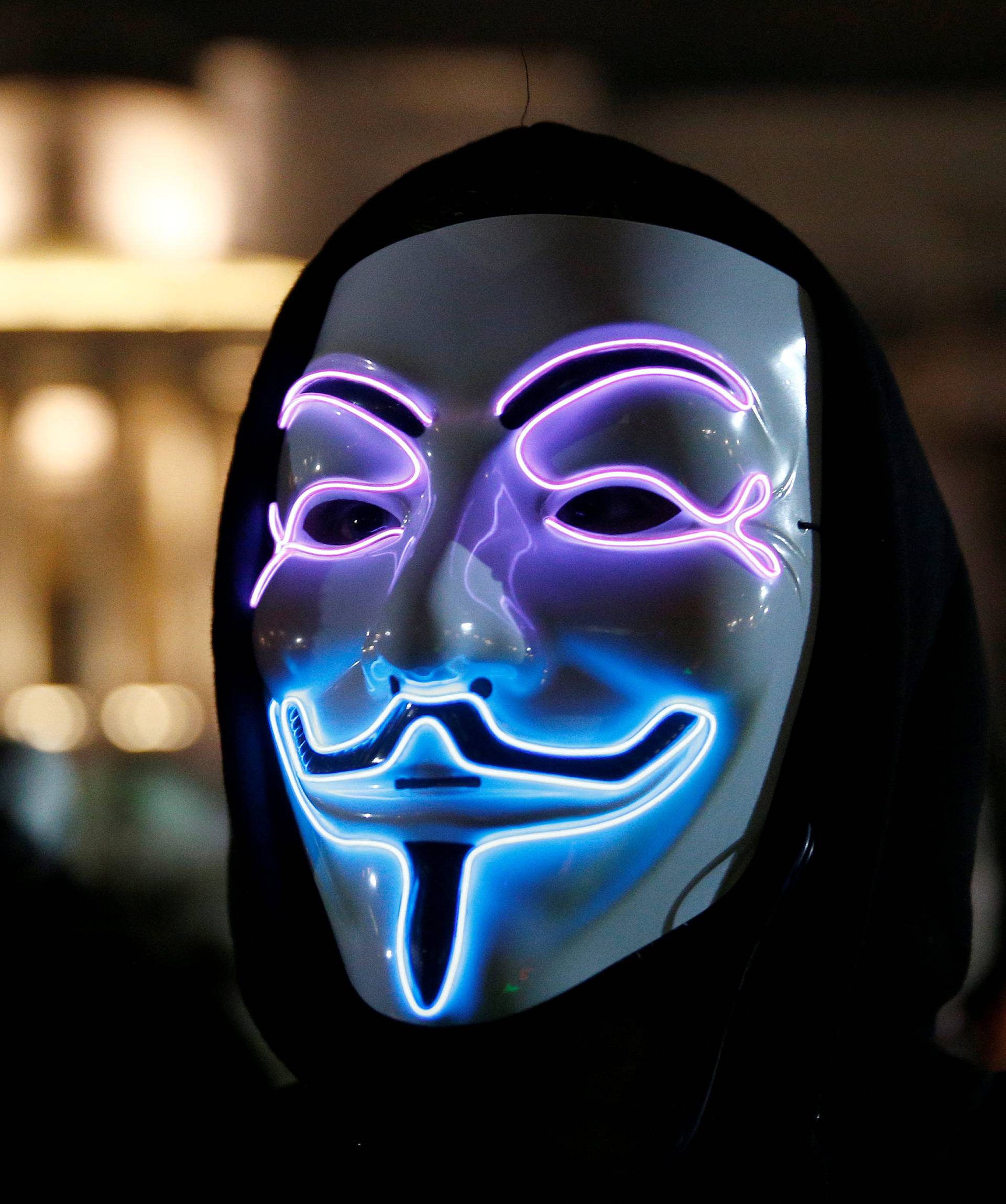 A mask wearing protester participates in the "Million Mask March" in London