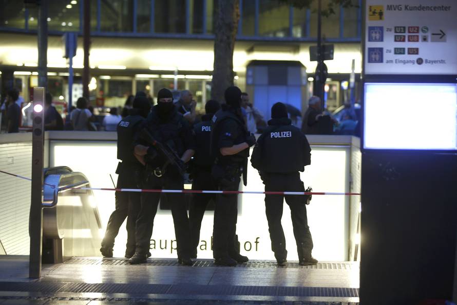 Special force police officers stand guard at entrance of main train station following shooting rampage at shopping mall in Munich