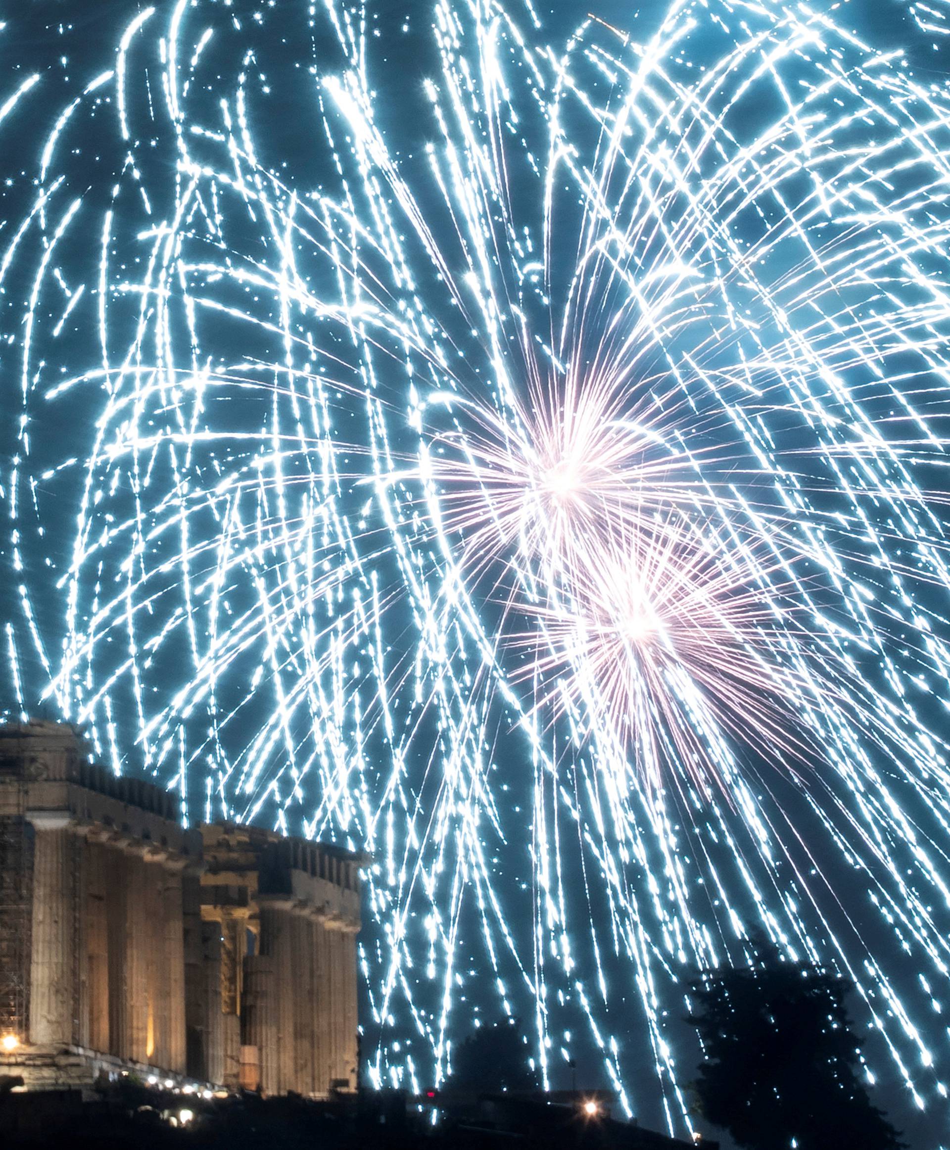 Fireworks explode over the ancient Parthenon temple atop the Acropolis hill during New Year's day celebrations in Athens