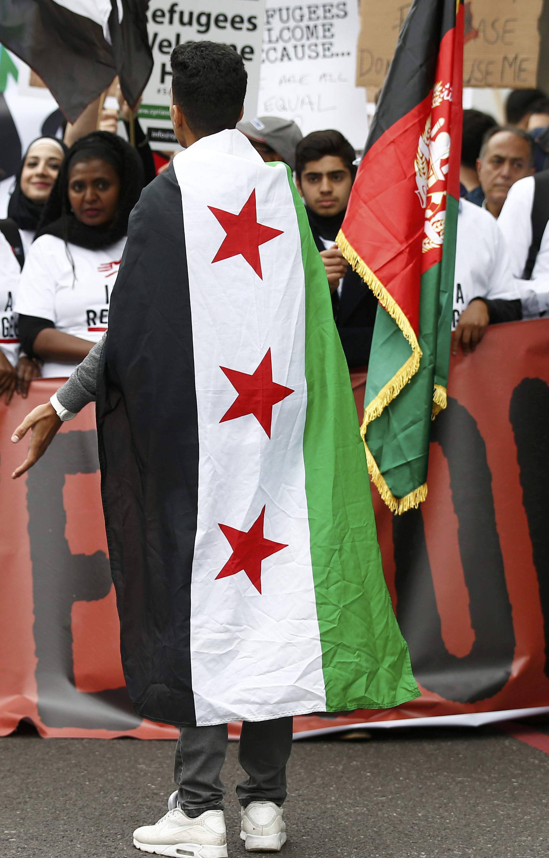 Demonstrators including refugees march to the Houses of Parliament during a protest in support of refugees, in London