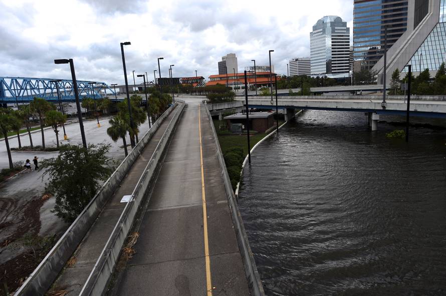 Women walk through floodwaters after Hurricane Irma in Jacksonville,