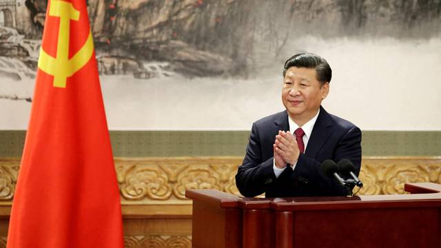 FILE PHOTO: Chinese President Xi Jinping claps after his speech in Beijing