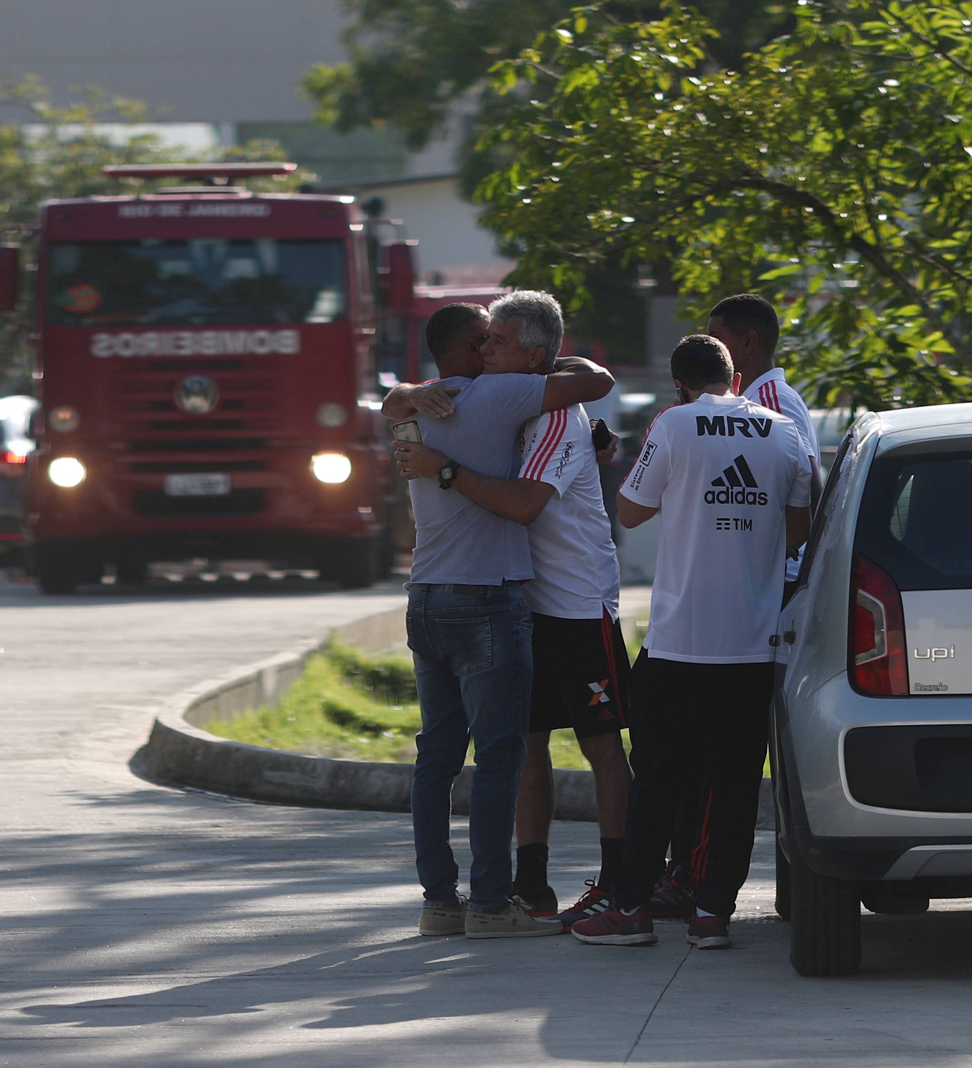 People wait for information in front of the training center of Rio's soccer club Flamengo, after a deadly fire in Rio de Janeiro