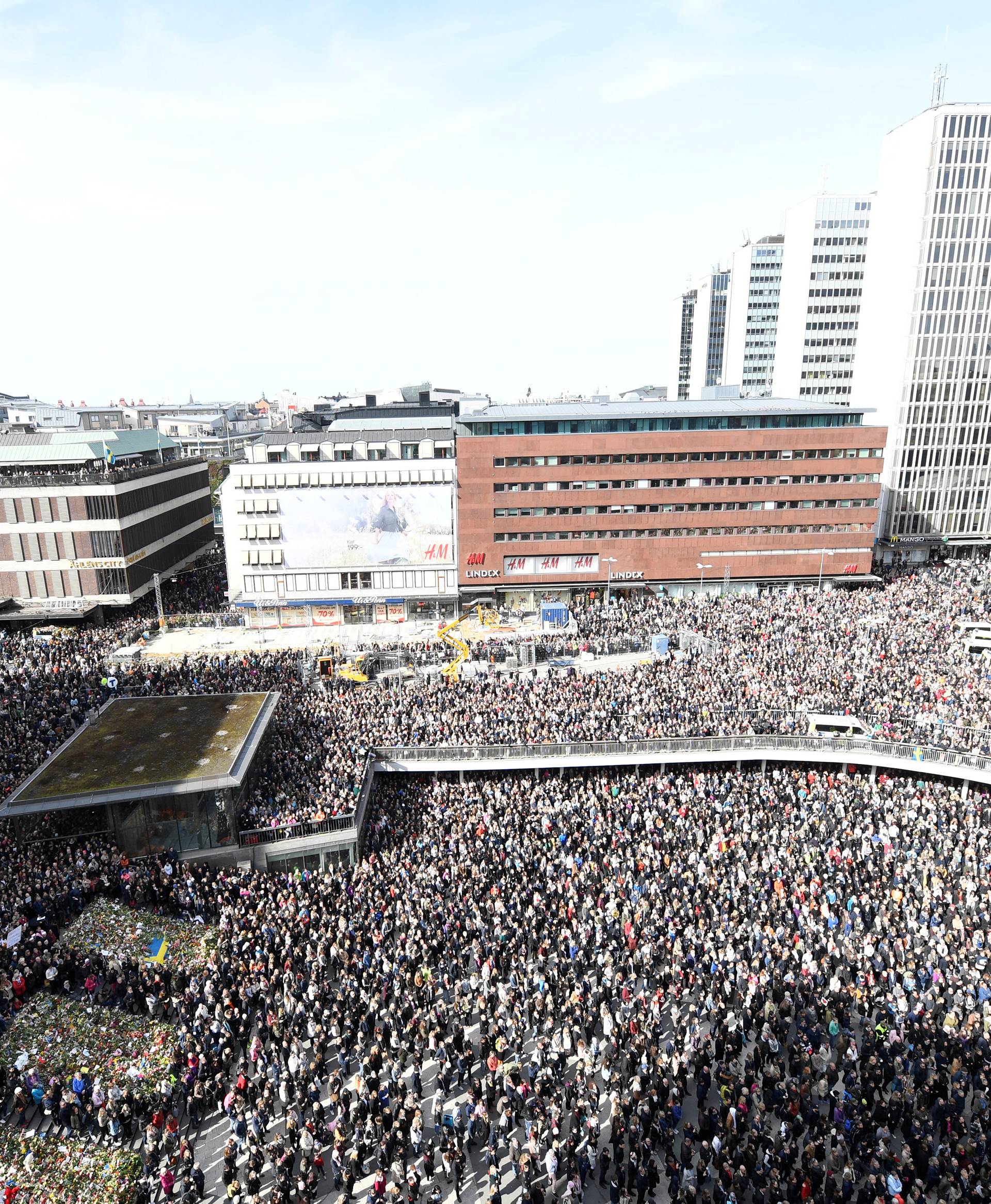 People gather in Sergels torg in central Stockholm for a "Lovefest" vigil against terrorism following Friday's attack