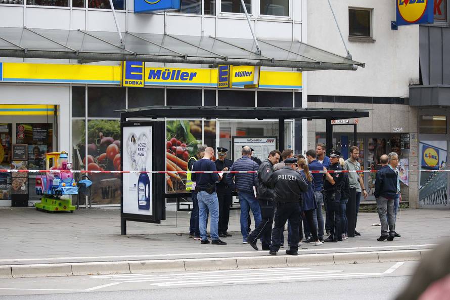 Security forces are seen after a knife attack in a supermarket in Hamburg