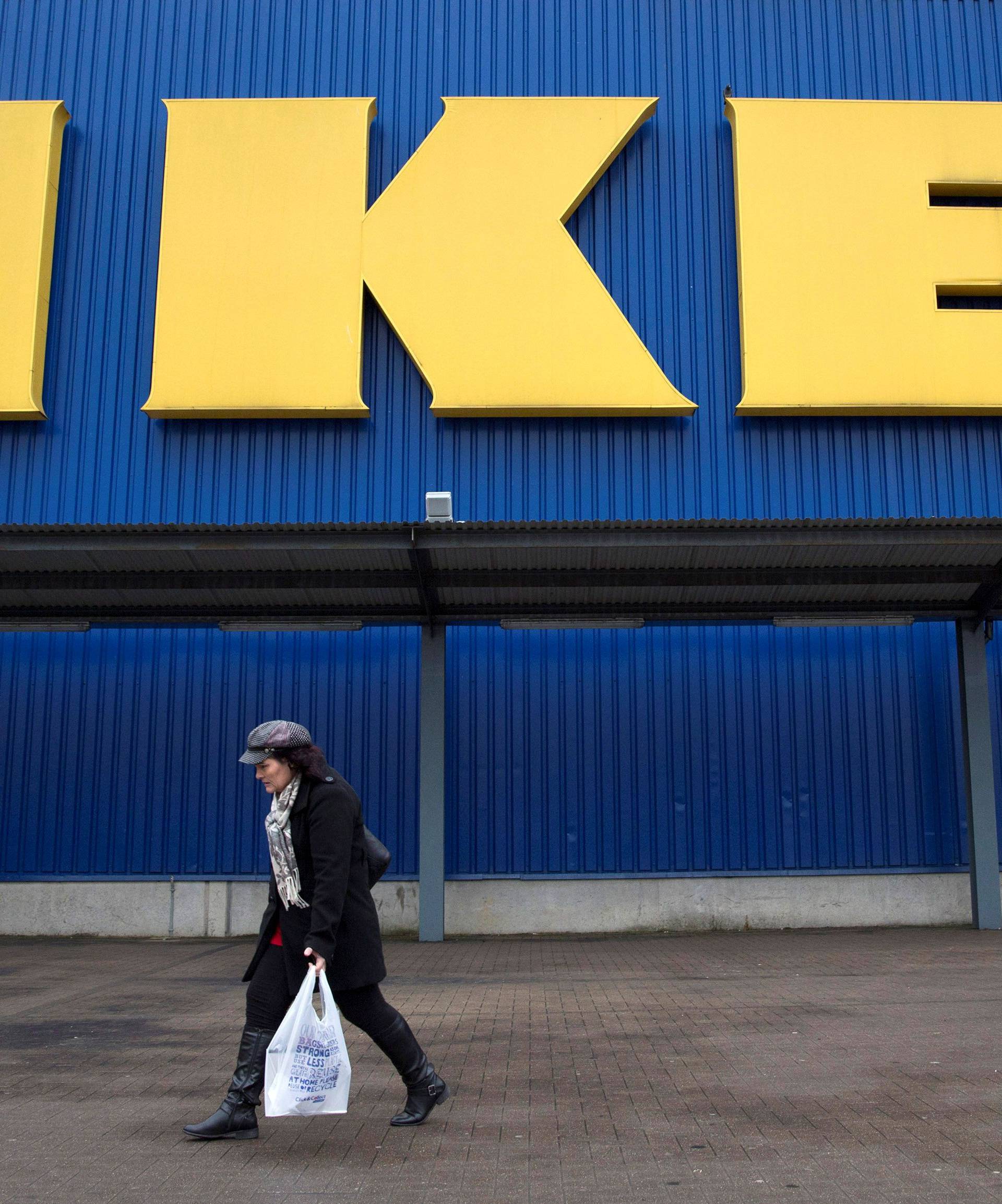 FILE PHOTO: A shopper walks past a sign outside an IKEA store in Wembley, north London