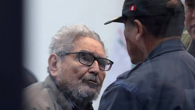 FILE PHOTO: Shining Path founder Abimael Guzman attends a trial during sentence of a 1992 Shining Path car bomb case in Miraflores, at a high security naval prison in Callao