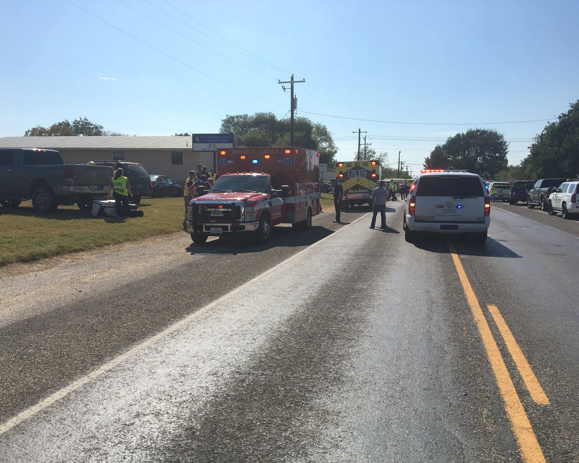 A police car and a medical vehicle are seen near the First Baptist Church in Sutherland Springs