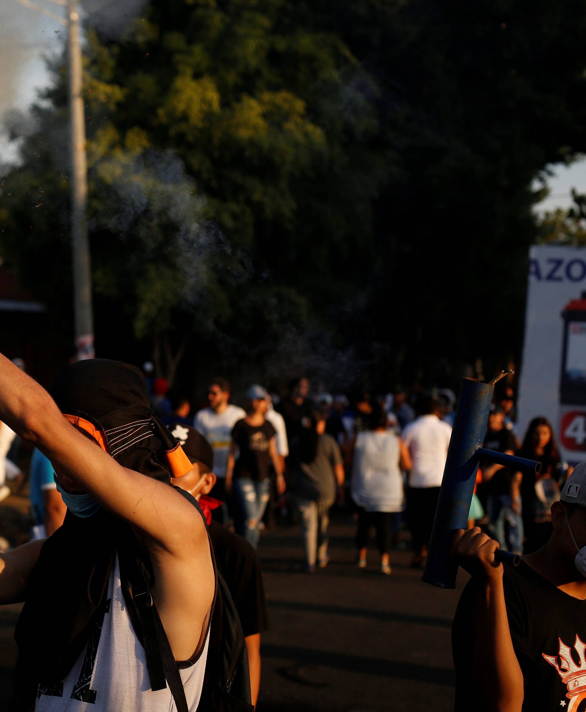 A demonstrator fires a homemade weapon during a protest against police violence and the government of Nicaraguan President Daniel Ortega in Managua