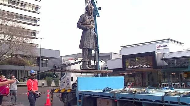 Statue of British Naval Captain John Fane Charles Hamilton is lifted out of the ground and onto a truck in Hamilton