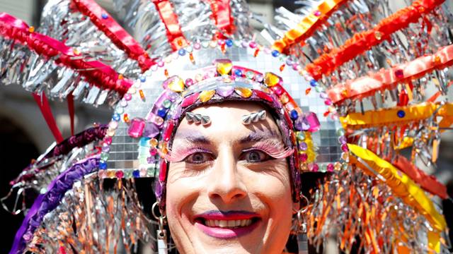 A participant smiles during the Zurich Pride Festival parade in Zurich