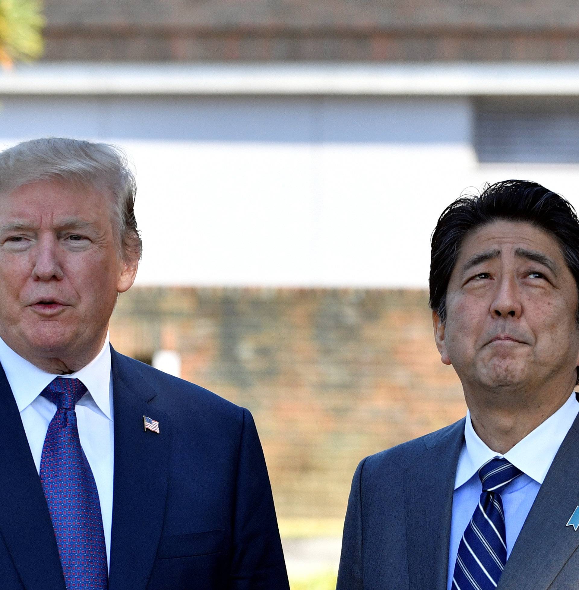 U.S. President Donald Trump meets with Japan's Prime Minister Shinzo Abe upon his arrival at the Kasumigaseki Country Club in Kawagoessa