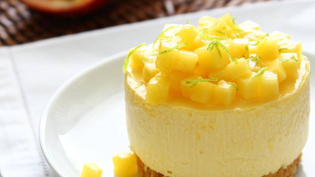 Modern style mango cheese tart on white plate