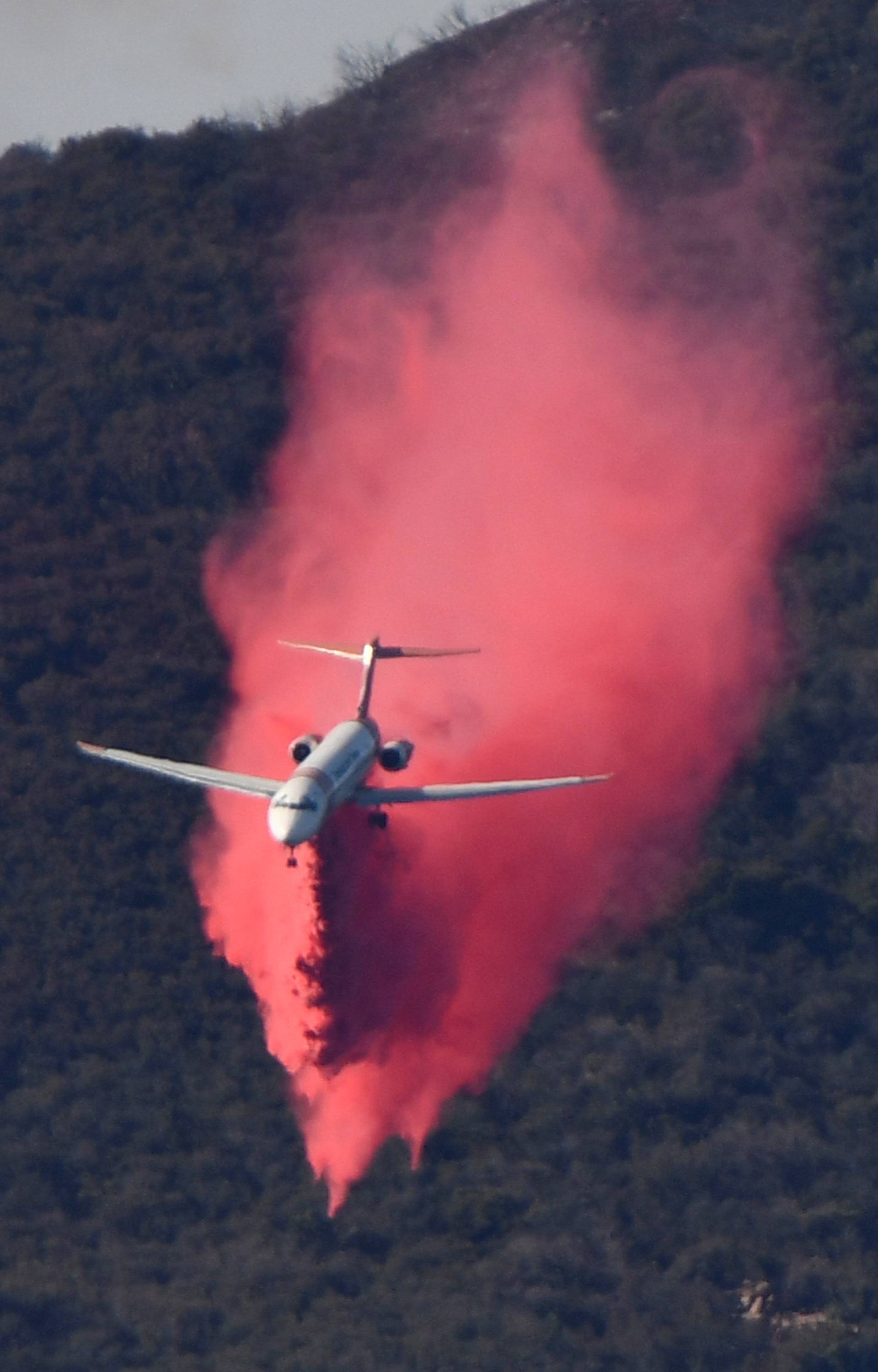 An aircraft drops fire retardant on the Thomas Fire, a wildfire in Fillmore, California