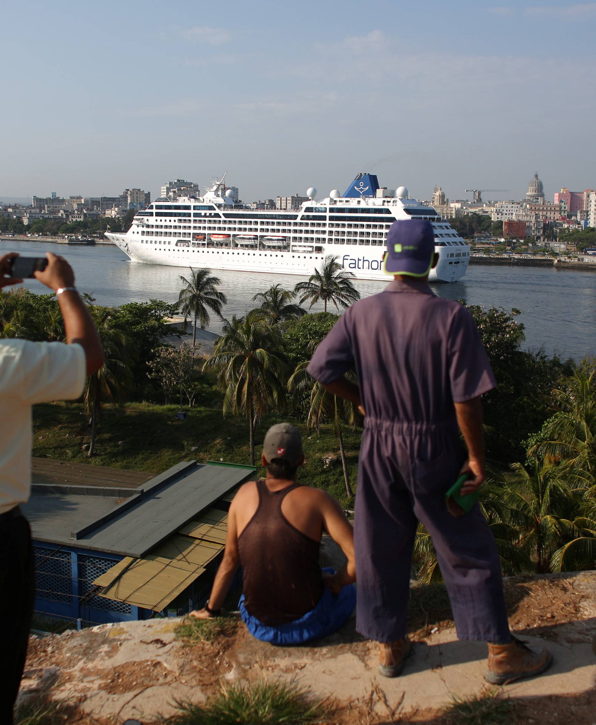 People look at the arrival of U.S. Carnival cruise ship Adonia at the Havana bay, the first cruise liner to sail between the United States and Cuba since Cuba's 1959 revolution, Cuba