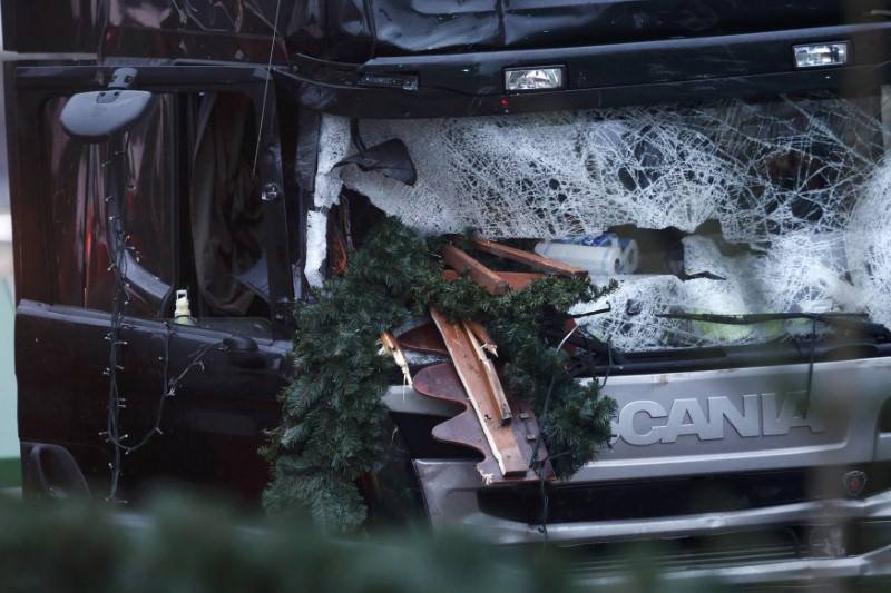 The damaged windscreen of the truck which ploughed into a crowded Christmas market last night is pictured in the German capital Berlin
