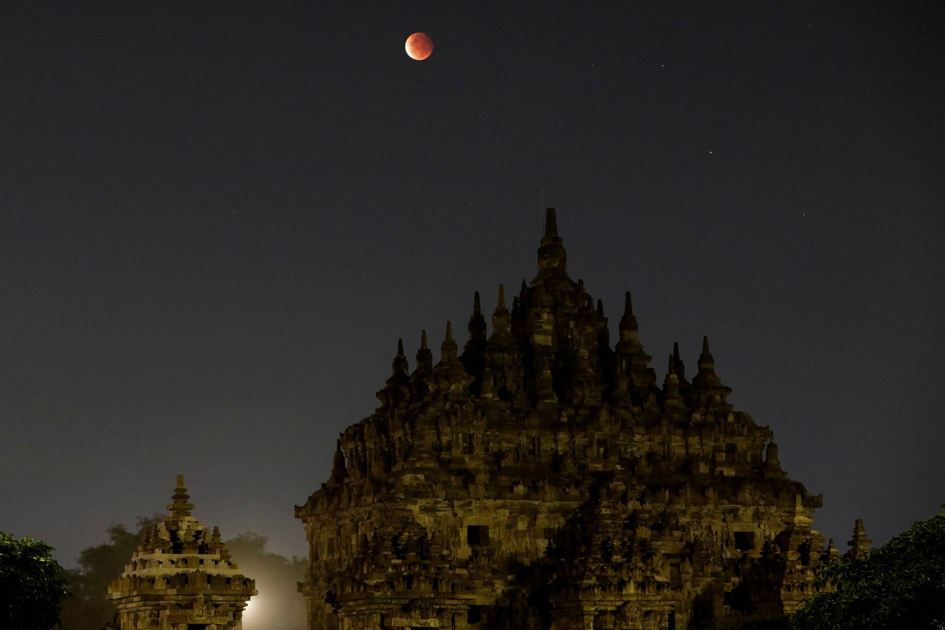 A Super Blood Moon rises over the Plaosan temple during total lunar eclipse in Klaten