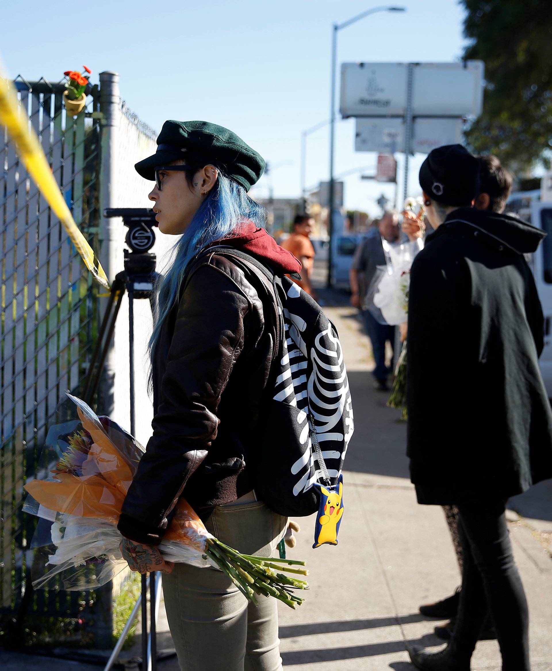 Firefighters stand outside a warehouse after a fire broke out during a electronic dance party late Friday evening, resulting in at least nine deaths and many unaccounted for in the Fruitvale district of Oakland, California