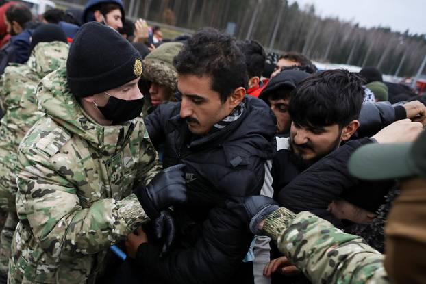 Migrants gather to receive food near the Belarusian-Polish border in the Grodno region