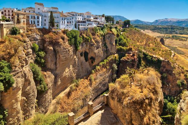 buildings standing on the edge of a cliff in Ronda, Spain