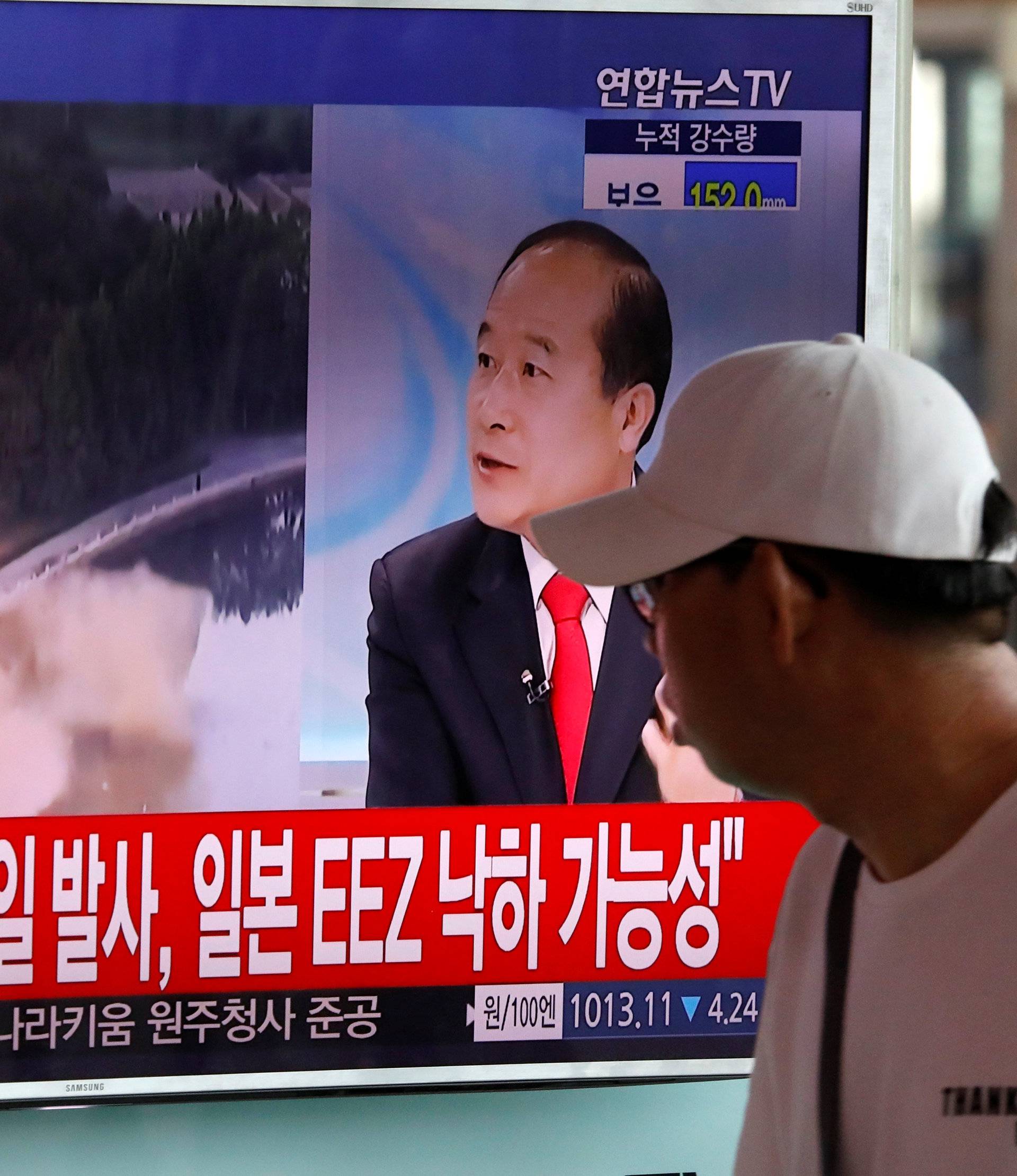 A man watches a TV broadcast of a news report on North Korea's ballistic missile test, at a railway station in Seoul