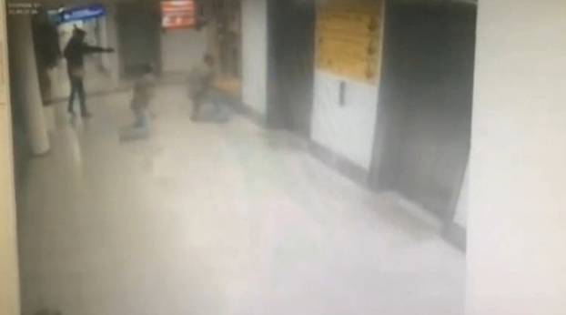 A still image from CCTV footage from Istanbul airport, Turkey released June 30, 2016 shows an attacker shooting a plain clothes police officer at point blank range with a pistol.