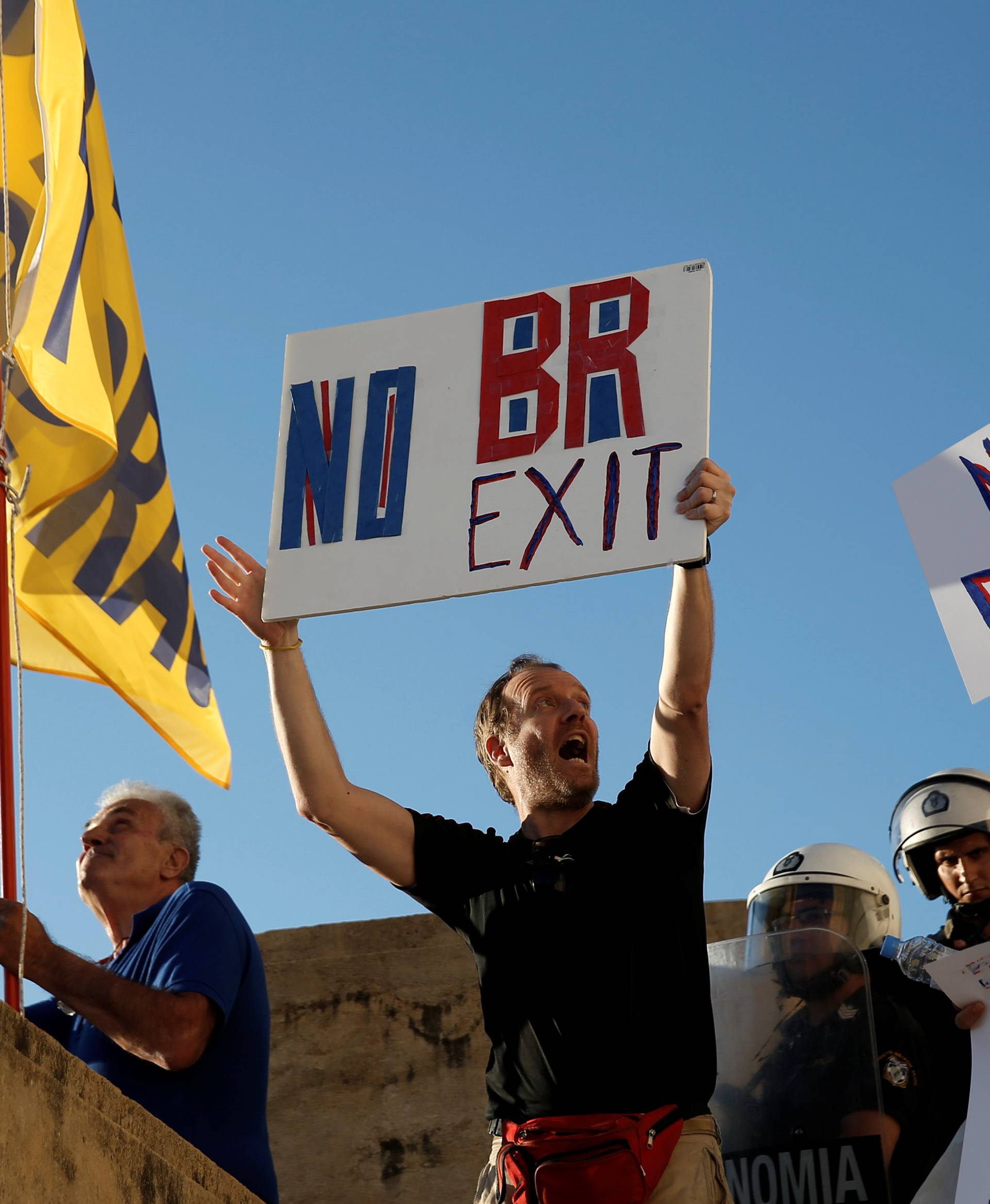 Anti-government demonstrators hold placards reading "No Brexit" during a protest outside the parliament in Athens