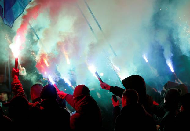 Activists of opposition parties burn flares during a rally demanding to break an agreement with Russia on the use of the Azov Sea and the Kerch Strait, in front of the parliament building in Kiev