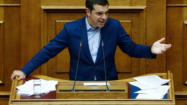 Greek Prime Minister Alexis Tsipras addresses lawmakers during a parliamentary session before a vote following a motion of no confidence by the main opposition in dispute over a deal on neighbouring Macedonia's name, in Athens