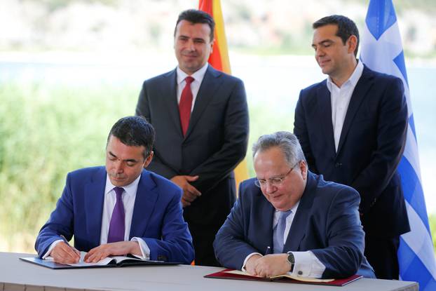 Greek Foreign Minister Kotzias and his Macedonian counterpart Dimitrov sign an accord to settle a long dispute over the former Yugoslav republic