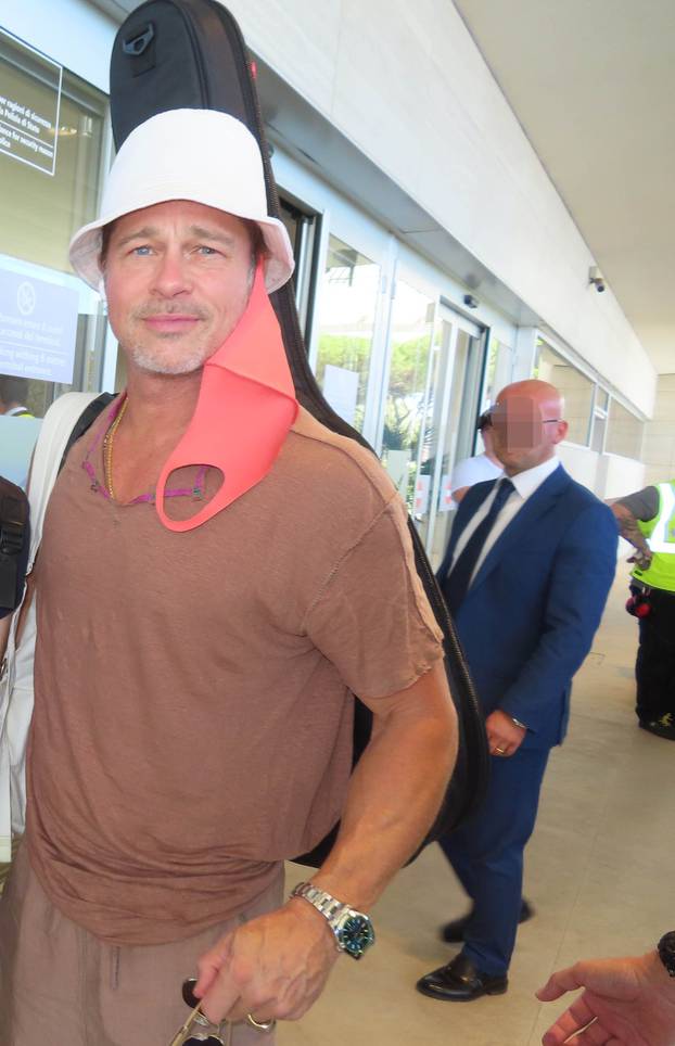 Brad Pitt spotted at the airport of Rome, carrying his guitar. The actor spent secretely one day in Rome to meet his kids, currently in town with mum Angelina Jolie.