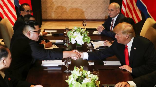 U.S. President Donald Trump shakes hands with North Korea's leader Kim Jong Un before their meeting in Singapore