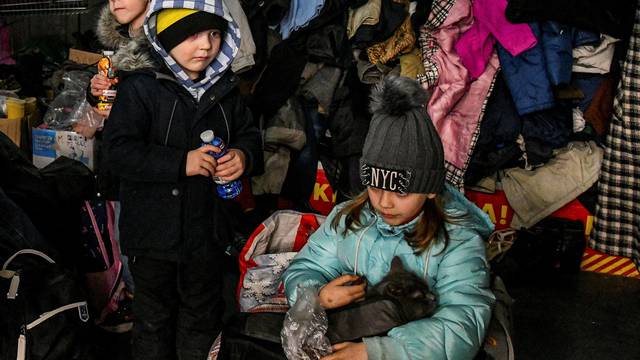 Children rest at a collecting point after fleeing from Mariupol to Zaporizhzhia