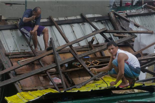 Residents repair their damaged houses after Typhoon Kammuri hit Legazpi City, Albay
