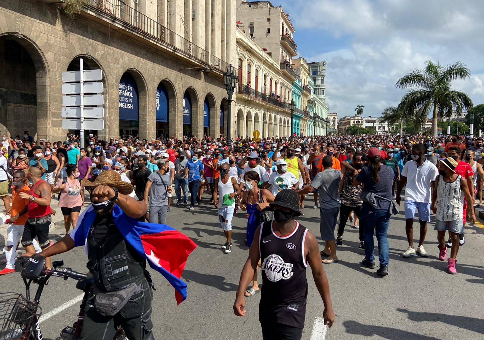 People walk during protests against and in support of the government, in Havana