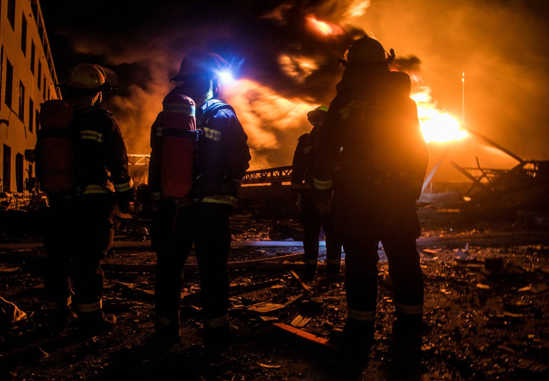 Firefighters work on extinguishing the fire following an explosion at the pesticide plant owned by Tianjiayi Chemical, in Xiangshui