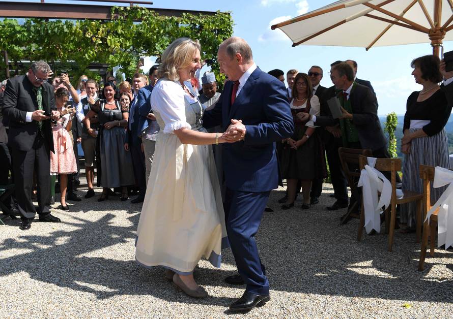 Austria's Foreign Minister Kneissl dances with Russia's President Putin at her wedding in Gamlitz