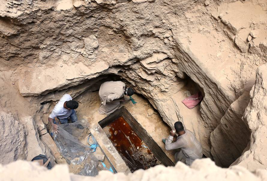 Archaeologists unearth coffin containing three mummies with sewage water and bones inside, in Alexandria