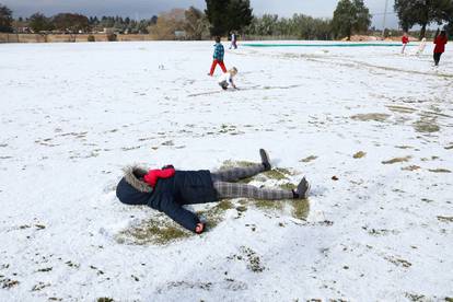Children play in the snow at Laerskool Orion, a school located in Brackenhurst